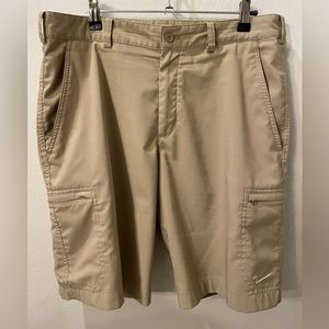 Nike Golf shorts. Tan in color. Size 32. Double zip cargo pockets.